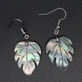 Macro detail of iridescent monstera leaf earrings crafted from natural abalone shell. - Tropical Iridescent Shell (4)