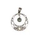 Close-up of vintage silver moon pendant with natural stone and Celtic knotwork - Labradorite