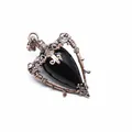 Detailed view of a vintage medieval style black teardrop stone pendant with copper frame - Obsidian