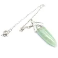 Detail shot of a natural green stone bullet crystal pendulum with silver chain - Aventurine Jade
