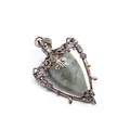 Detailed macro view of vintage bronze-tone bottle pendant with natural grey teardrop stone - Labradorite