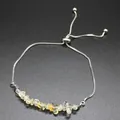Detail of an adjustable bracelet with irregular natural citrine stones on a silver chain. - Citrine