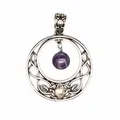 Close-up of a vintage silver-tone pendant with a dangling purple amethyst bead detail. - Amethyst