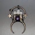 Detailed macro view of vintage moon and star pendant with raw white crystal and purple stone - Star Moon Quartz Crystal Pendant Style