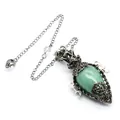 Close-up of antique silver egg-shaped green crystal pendulum with pentagram detail - Pendant With Pendulum Chain / Aventurine Jade