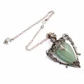 Detailed view of the vintage green stone pendulum with ornate bronze metal frame - Green Aventurine + Pendulum Chain