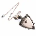 Detailed view of medieval retro rose quartz pendulum necklace with ornate bronze frame - Rose Quartz + Pendulum Chain