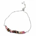 Gros plan d'un bracelet réglable en argent avec des éclats de pierres naturelles colorées - Tourmaline