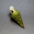 Detail of resin hexagonal cone filled with green peridot chips and copper coil. - Peridot-Gold Tone