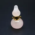 Close-up of a natural rose quartz gourd perfume bottle pendant with gold hardware - Gourd / Rose Quartz (Gold Cap)