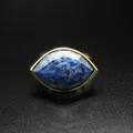 Detail view of an elegant gold ring with a large faceted blue marquise-cut gemstone - Blue Sodalite / Adjustable Open