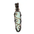 Close-up of a wire-wrapped hexagonal green stone pendant with intricate copper swirls - Aventurine (Bronze-tone Wrapped) / Light Green