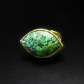 Macro view of a faceted marquise-cut green natural gemstone ring in gold setting - African Pine Stone / Adjustable Open