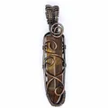 Close-up detail of wire-wrapped natural tiger eye stone hexagonal pillar pendant - Tiger Eye (Bronze-tone Wrapped) / Tan