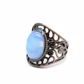 Close-up of a vintage hollow-out ring with a blue agate stone in antique finish - Opal