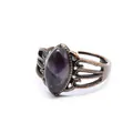 Dettaglio macro di anello in bronzo vintage traforato con pietra naturale viola - Ametista