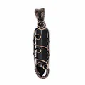 Close-up of a handcrafted wire-wrapped black hexagonal stone pendant with copper accents - Obsidian (Bronze-tone Wrapped)