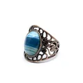 Close-up detail of the natural blue banded agate stone on a vintage bronze filigree hollow ring - Blue Agate