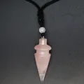Detail view of a rose quartz cone-shaped crystal pendant on a black braided cord necklace - Rose Quartz