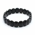 Detailed view of a faceted black natural stone bracelet featuring oval beads for women - Black Agate