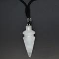Close-up detail of a white conical crystal pendant with a black cord necklace - White Crystal