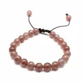 Macro view of 8mm natural strawberry quartz beaded bracelet with adjustable woven cord - Strawberry Quartz
