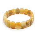 Detailed view of faceted yellow tiger's eye natural stone beads on a stretch bracelet. - Red Aventurine