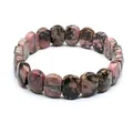 Detailed view of natural rhodonite stone bracelet with unique pink and black patterns - Faceted Panel Style / Rhodonite