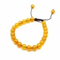 Detailed view of 8mm yellow natural stone beads on a hand-woven adjustable bracelet. - Agate