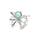 Close-up view of a unique silver spider open ring featuring a round light blue natural stone. - Open Ring / Larimar