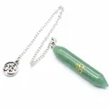 Close-up of green hexagonal crystal dowsing pendulum with golden Om symbol engraving - Aventurine Jade