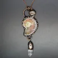 Close-up detail of a vintage medieval style ammonite fossil necklace with white crystal point - Ammonite Fossil Necklace