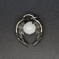 Close-up of crystal bead angel wing pendant made of natural stone and antique silver - White Crystal