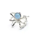 Detailed macro shot of a silver spider ring with a round light blue natural stone - Open Ring / Aquamarine