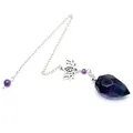 Macro detail of faceted fluorite crystal pendulum featuring a silver lotus charm and chain - Colorful Fluorite