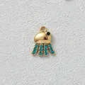 Macro view of gold-plated octopus charm inlaid with blue cubic zirconia stones for DIY jewelry - Jellyfish Style / Dark Blue