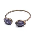 Macro detail of a vintage copper open cuff bracelet featuring two raw purple amethyst stones - Amethyst