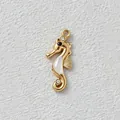Detailed view of a gold-plated seahorse pendant with white shell inlay and zirconia. - 2.45x1cm / White Seahorse