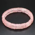 Macro view of a faceted square pink rose quartz bracelet with translucent tile texture. - Rose Quartz