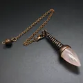 Detailed view of a rose quartz crystal dowsing pendulum with antique bronze chain. - Rose Quartz (Ancient Bronze)
