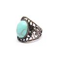 Close-up of vintage hollow ring with oval turquoise stone and antique copper finish - Turquoise