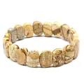 Detailed macro view of natural picture jasper stone slabs in a handmade stretch bracelet - Jasper