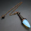 Macro detail of a vintage bronze pendulum pendant with a milky opal stone crystal - Opalite (Ancient Bronze)