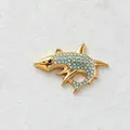 Close-up of a gold-plated shark pendant featuring sparkling light blue crystal inlay detail - Shark Style / Blue