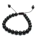 Close-up of 8mm matte black natural stone beads on a hand-woven adjustable bracelet. - Matte Onyx