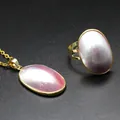 Close-up detail of pink Mabe pearl pendant and adjustable ring set in gold plating - Necklace Pendant and Ring Set / Pink-Gold