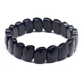 Macro detail of dark blue sandstone faceted bracelet showing shimmering particles - Blue Sandstone