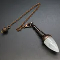 Detailed macro shot of a white crystal dowsing pendulum with an antique bronze metal chain. - Clear Quartz (Ancient Bronze)