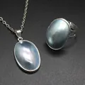 Detail view of handmade Mabe pearl shell pendant and adjustable ring set with iridescent sheen - Necklace Pendant and Ring Set / Blue-Silver