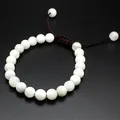 Detailed view of white 8mm natural stone bead bracelet with adjustable woven cord - Moonstone